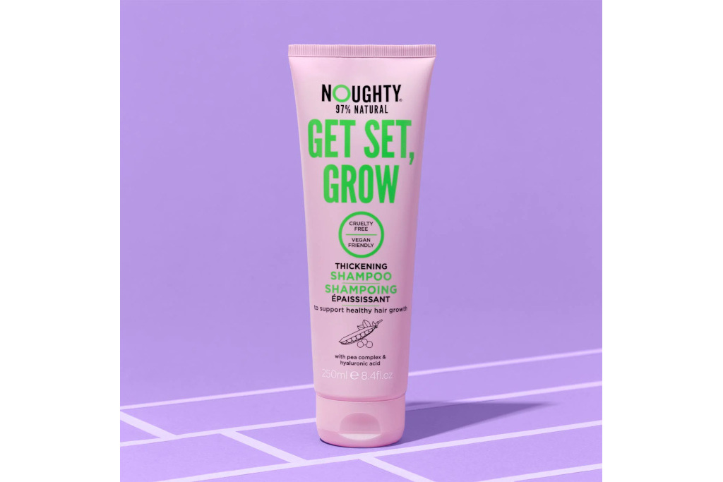Purple shampoo bottle on purple background