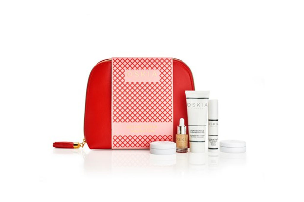 Red travel wash bag with small skincare products next to it
