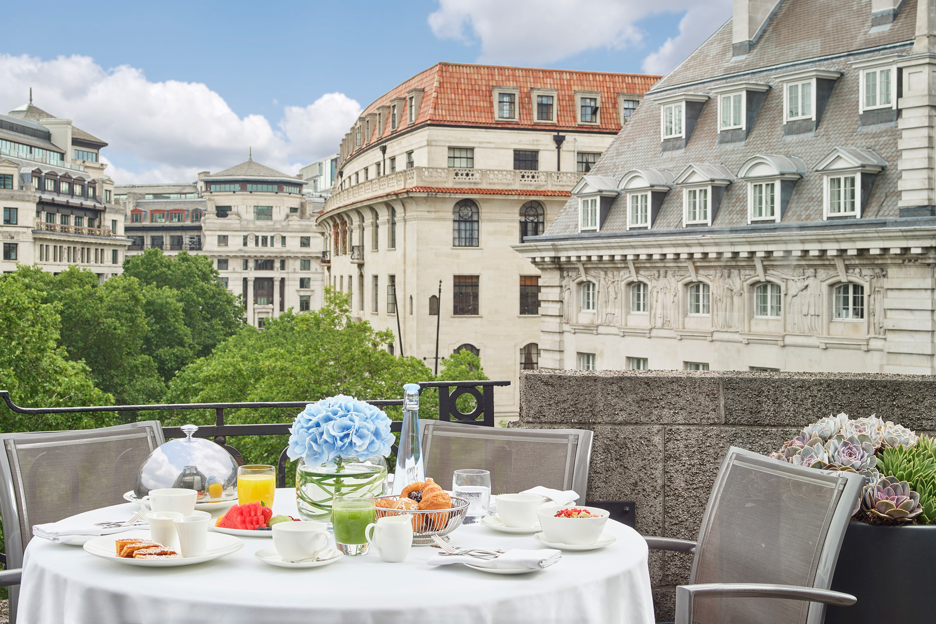 Terrace overlooking Covent Garden, with a table laid with flowers and white china