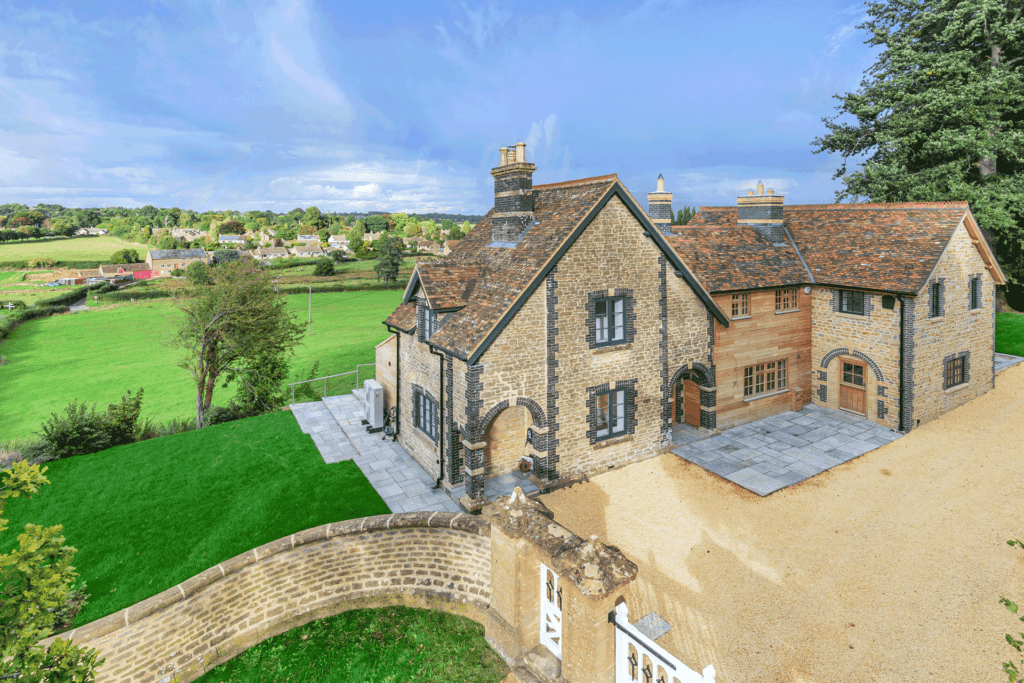 Barn with a wooden extension bridging two stone buildings