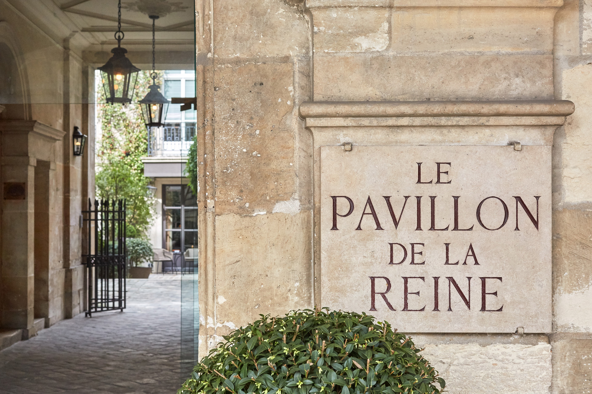 Sandstone building with engraved 'Pavilion de la Reine' sign