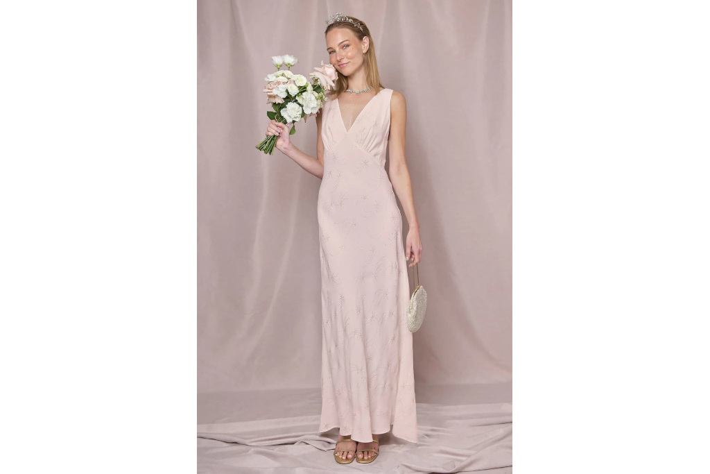 Woman in blush dress holding bouquet