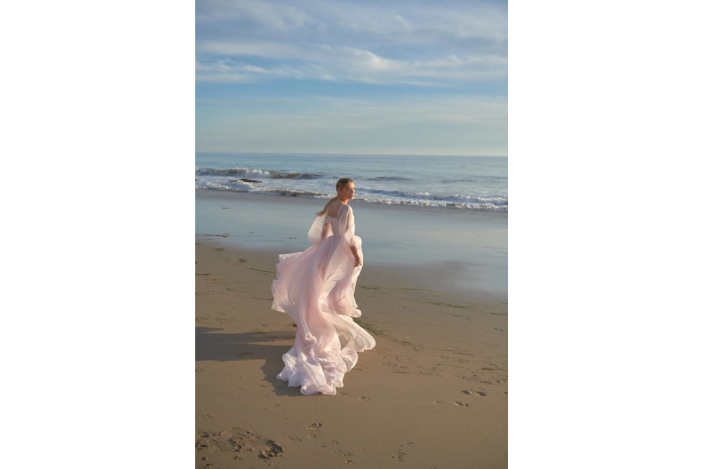 Woman in pink wedding dress on the beach