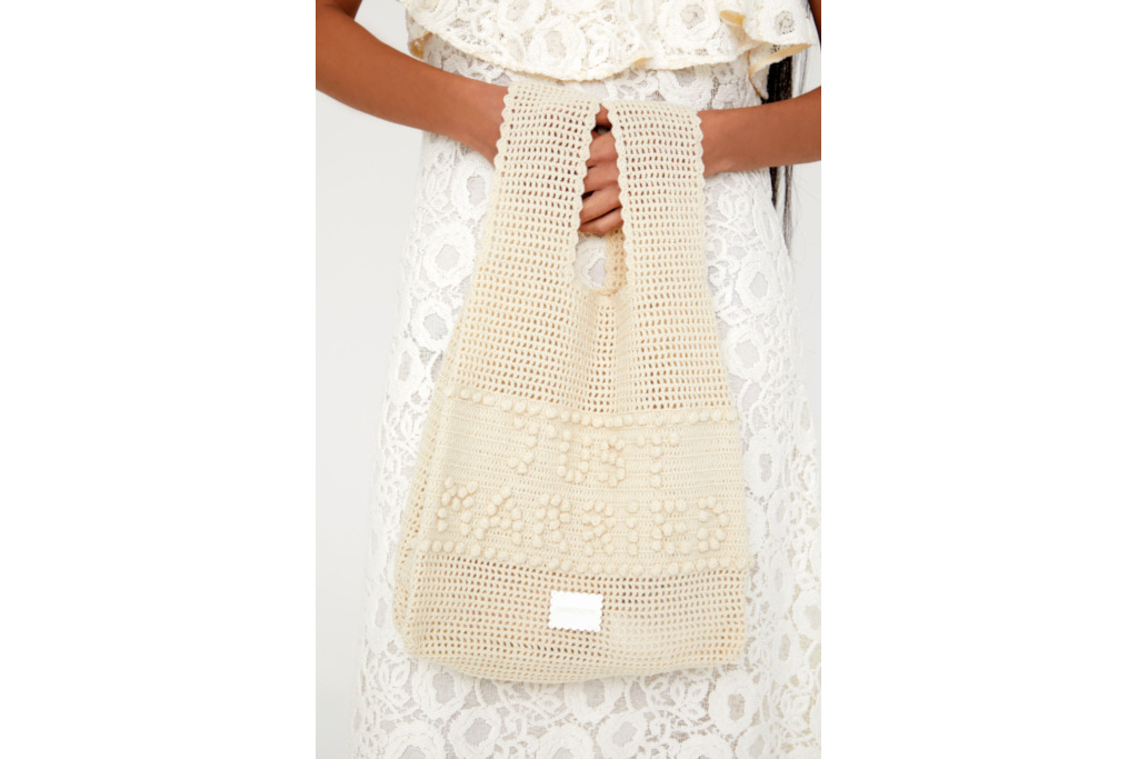 Close up of hands holding pearly bag