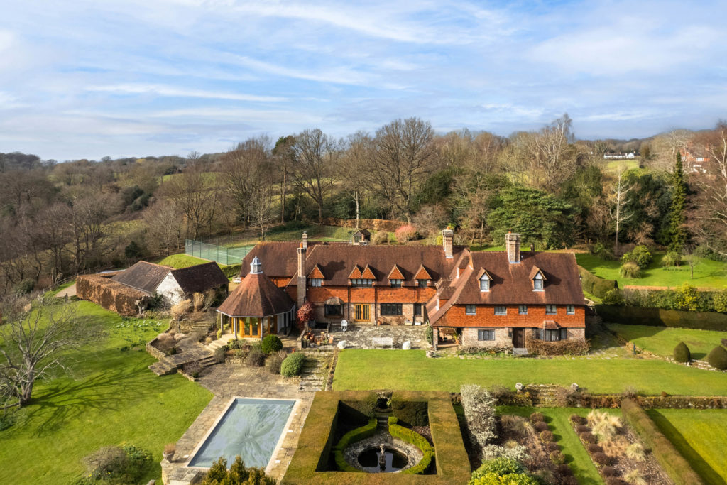 Country manor with swimming pool, tennis court and outbuildings.