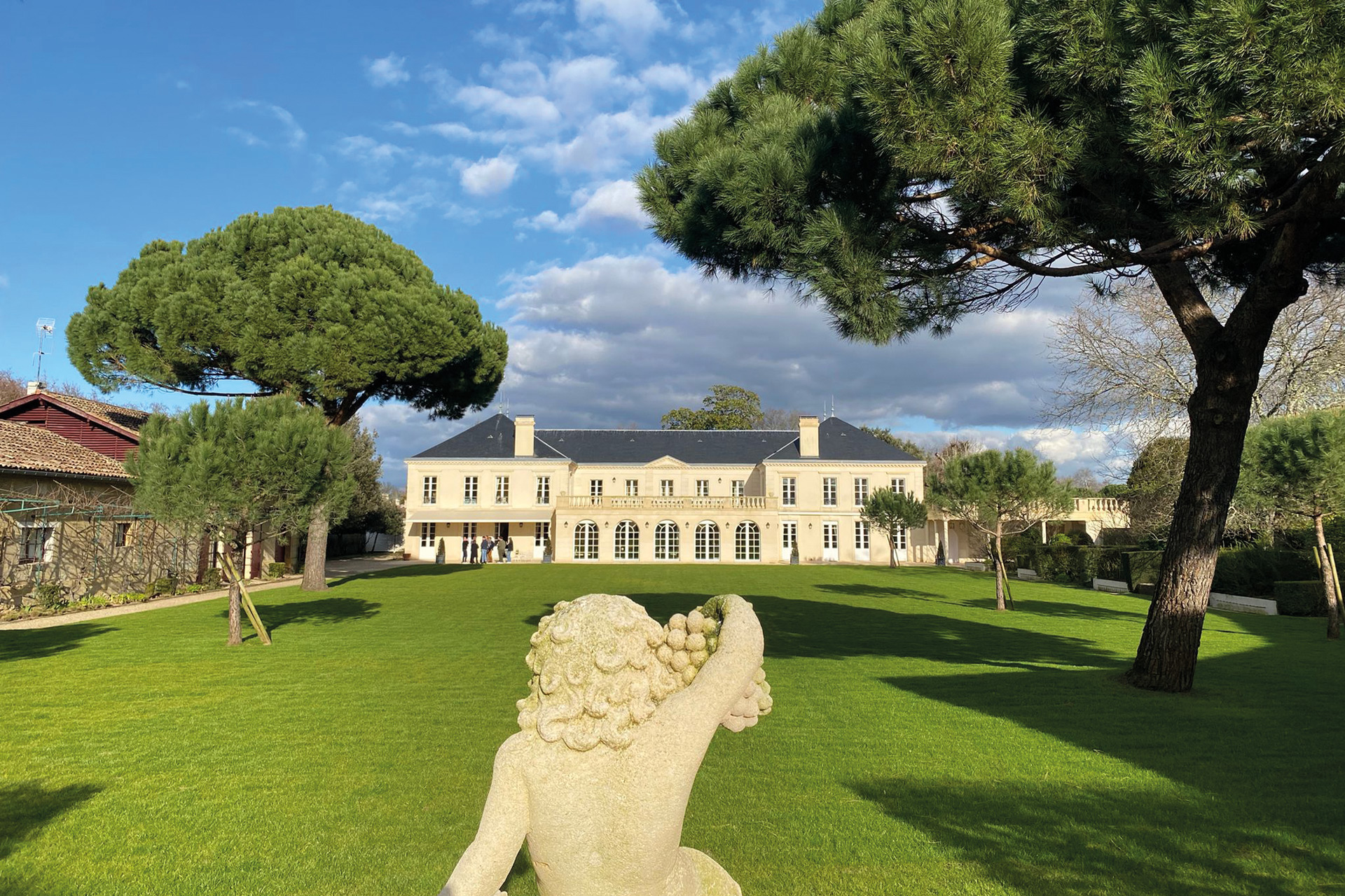 Vineyard with grand house and marble statue/fountain in front