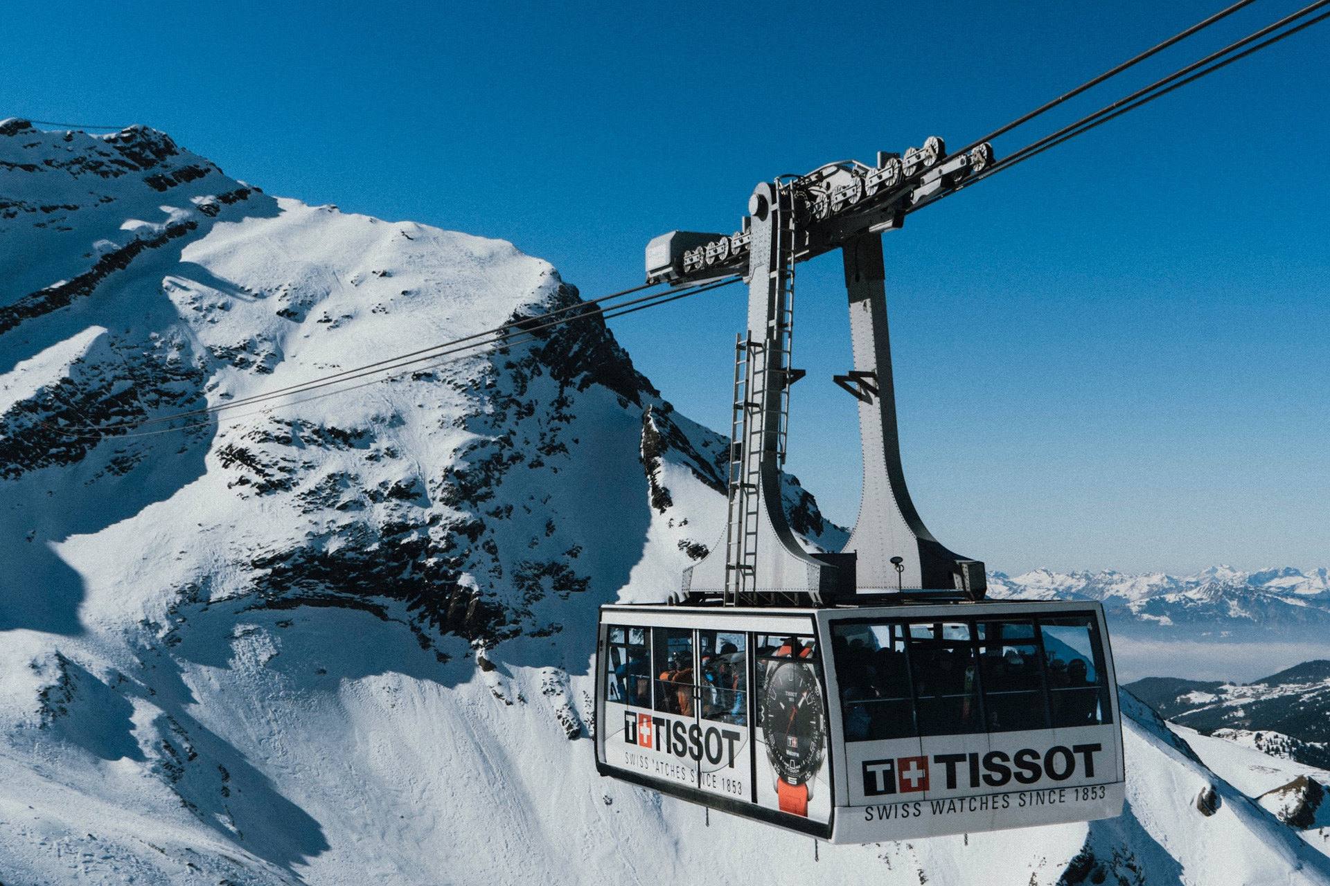 Cable car with Tissot brand and advertising.