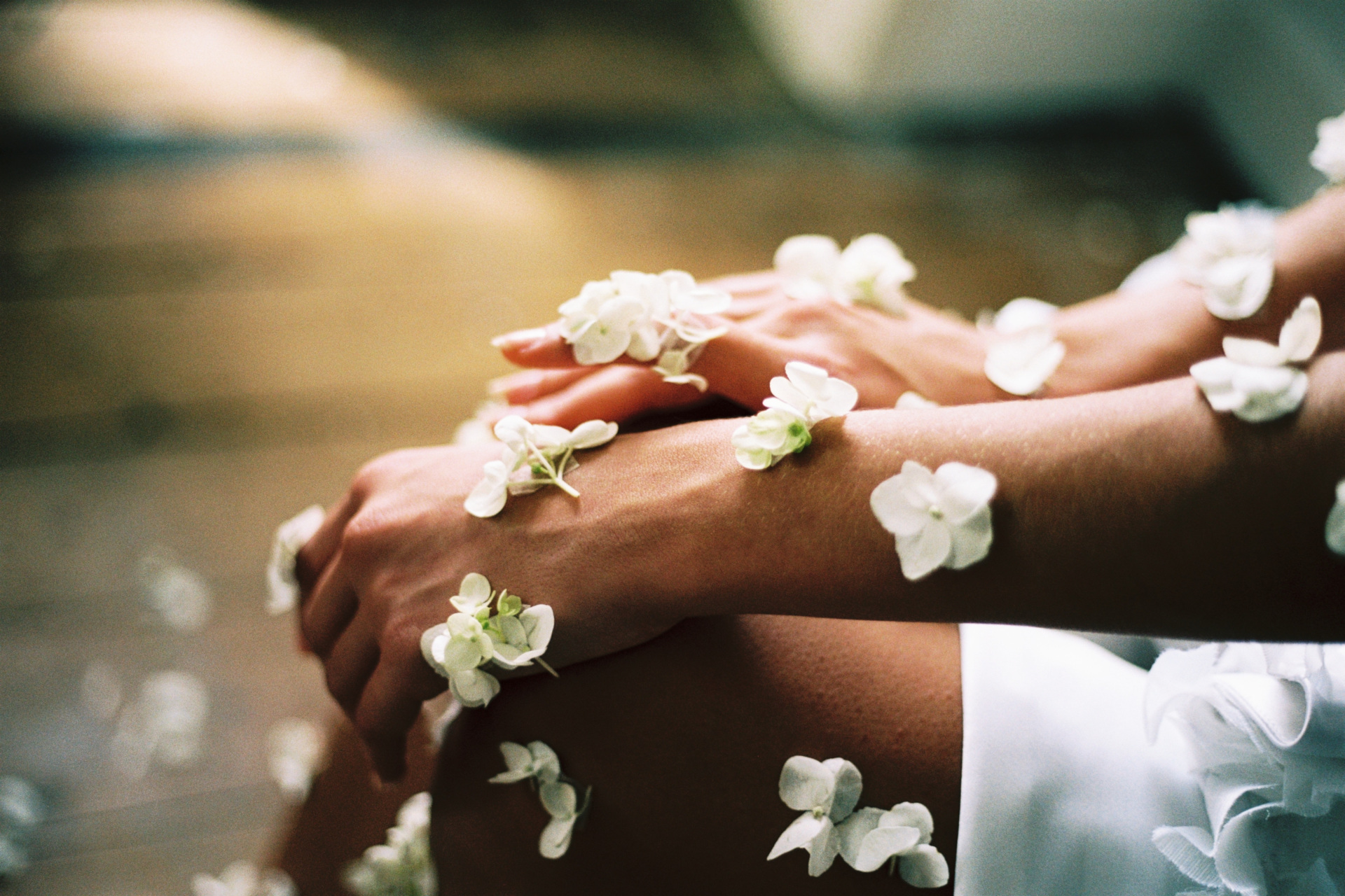 Woman sat down with white flowers on her