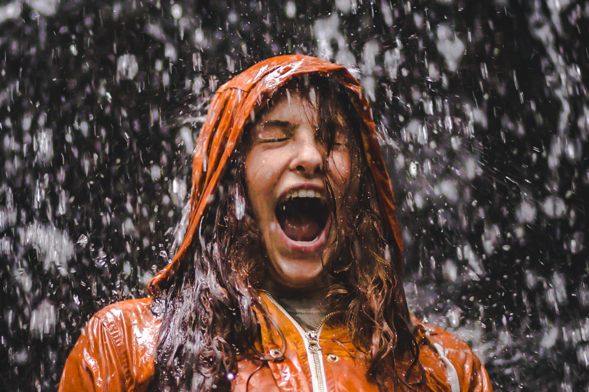 Woman in orange coat in the rain