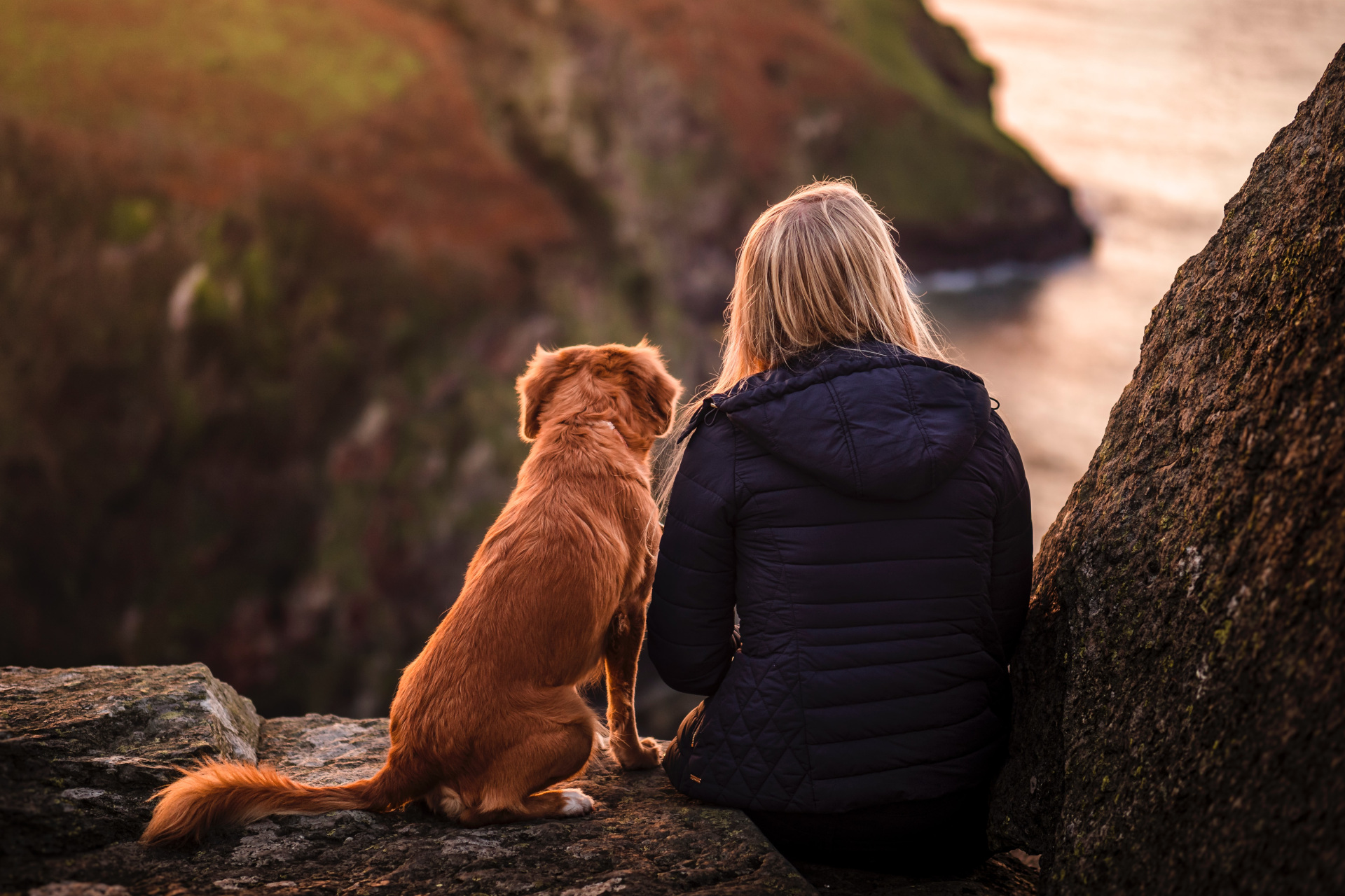 Woman sat with dog outdoors