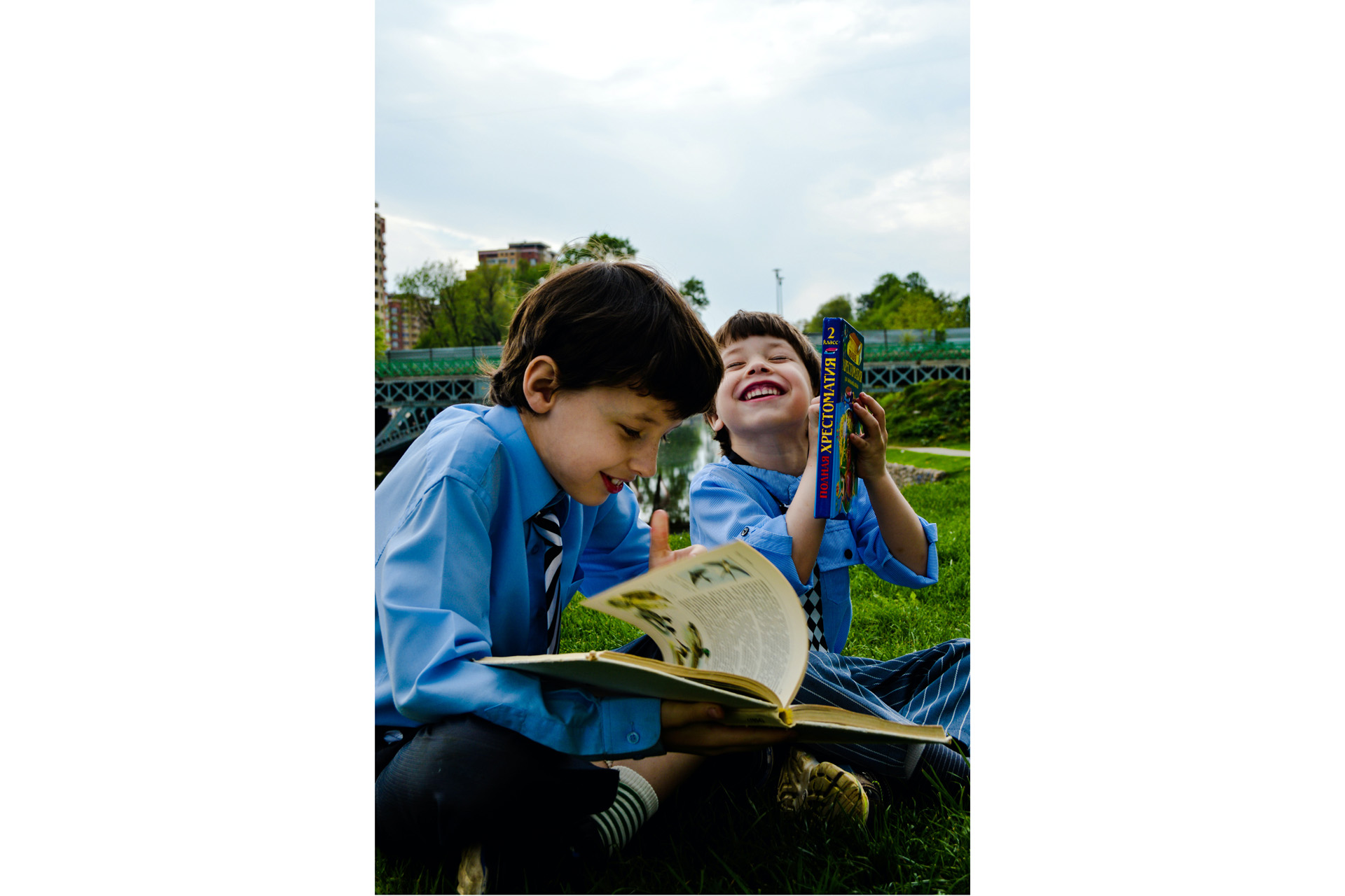 two young boys reading books