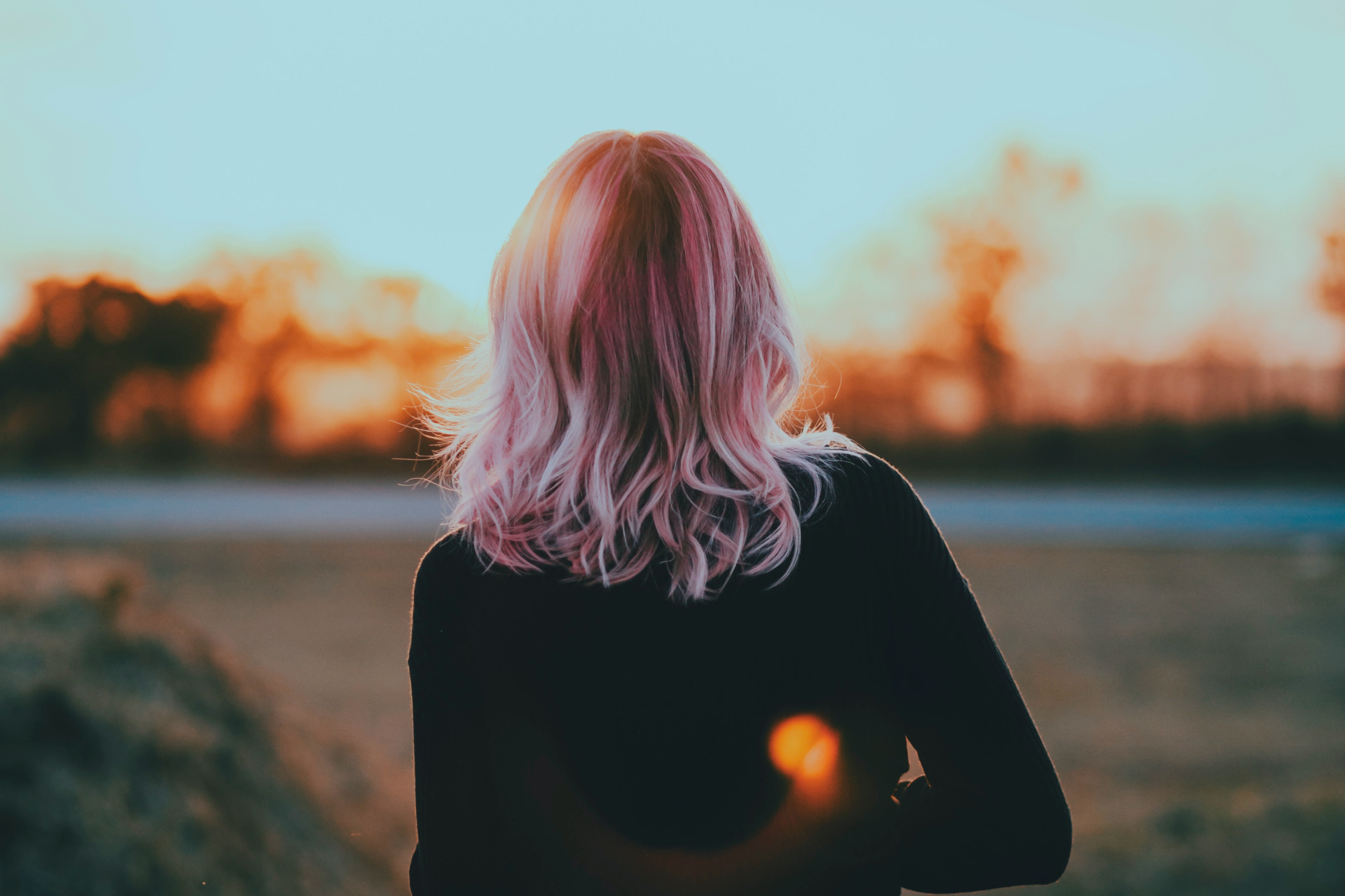 Back of woman's head, pink hair