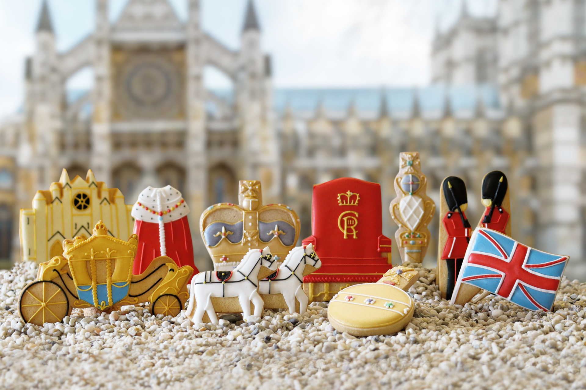 Coronation-themed biscuits lined up on faux gravel