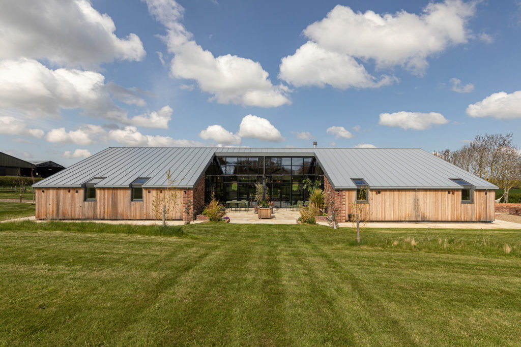 Timber barn conversion with a courtyard at its centre.