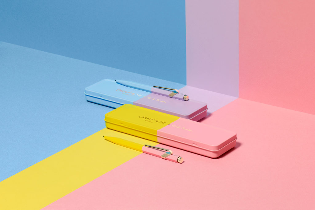 Pens and cases on multicoloured background