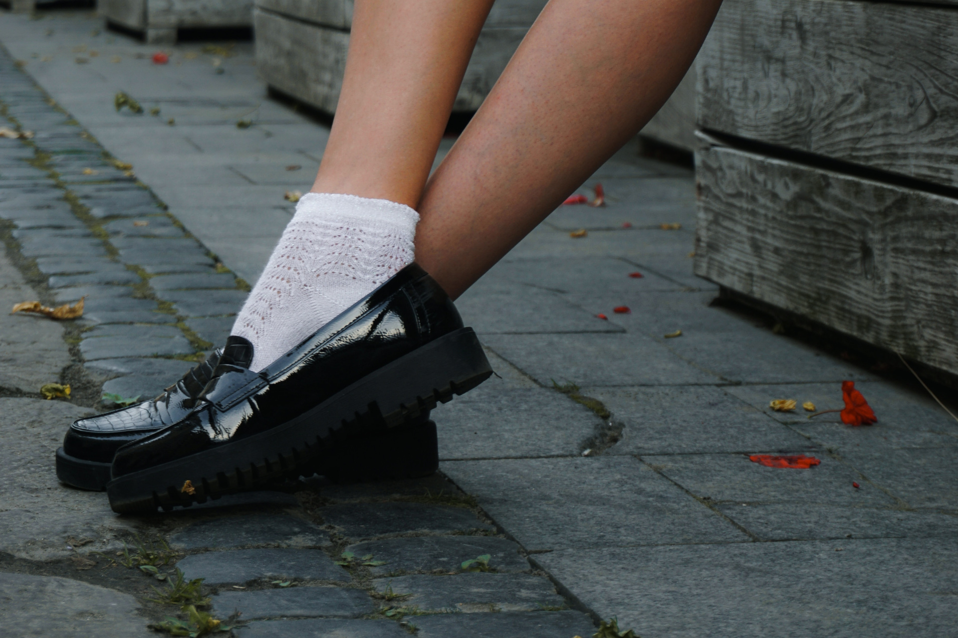 Close up of feet in white socks and black loafers