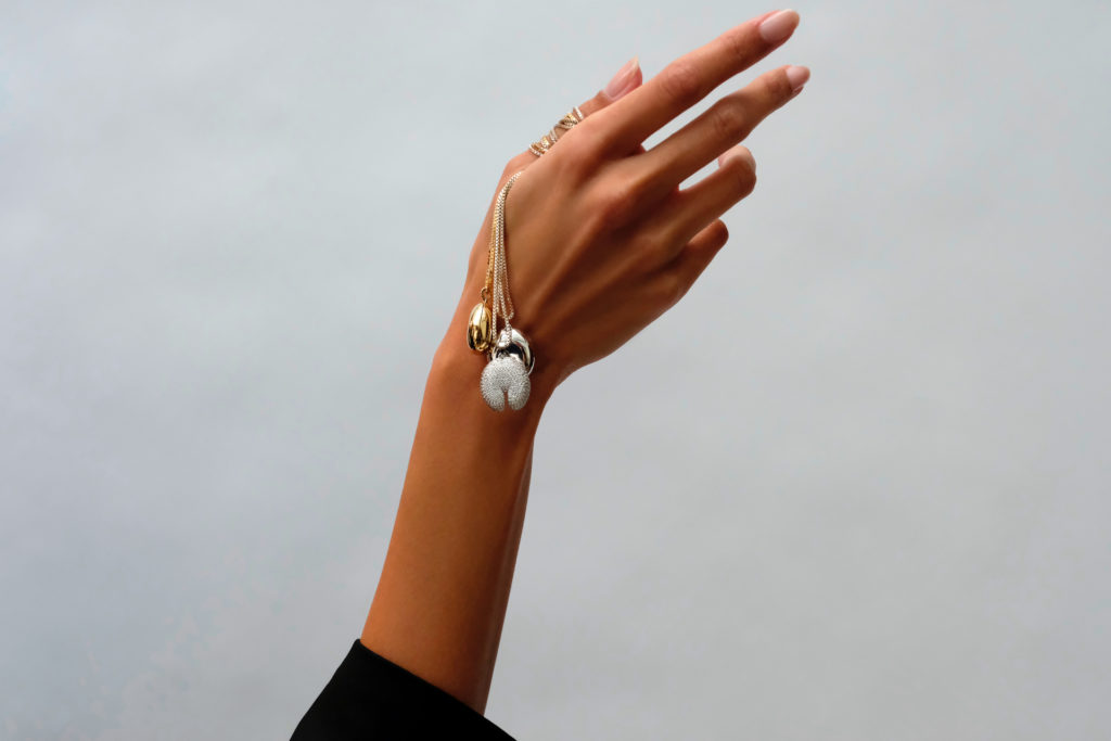 Hand with necklaces draped over it