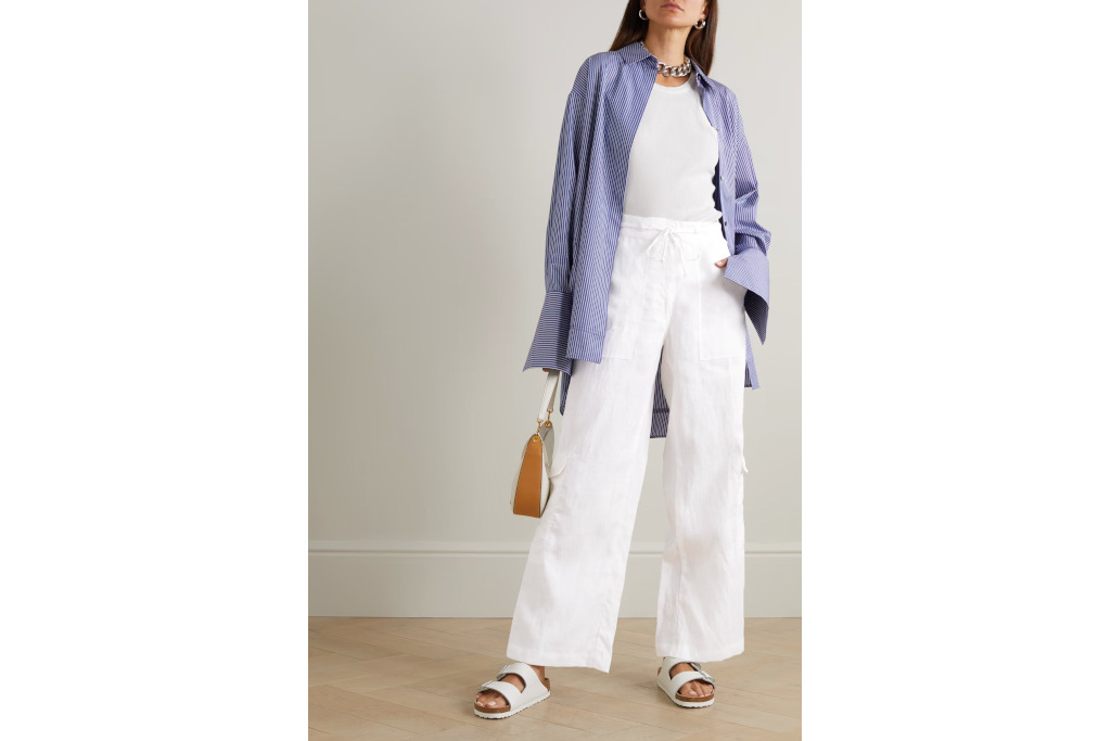 Woman in white top, trousers and blue shirt