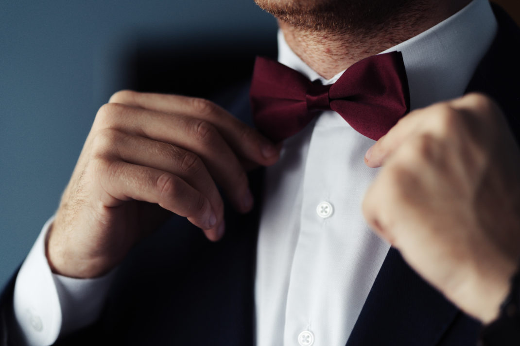 Close up of man adjusting bow tiw