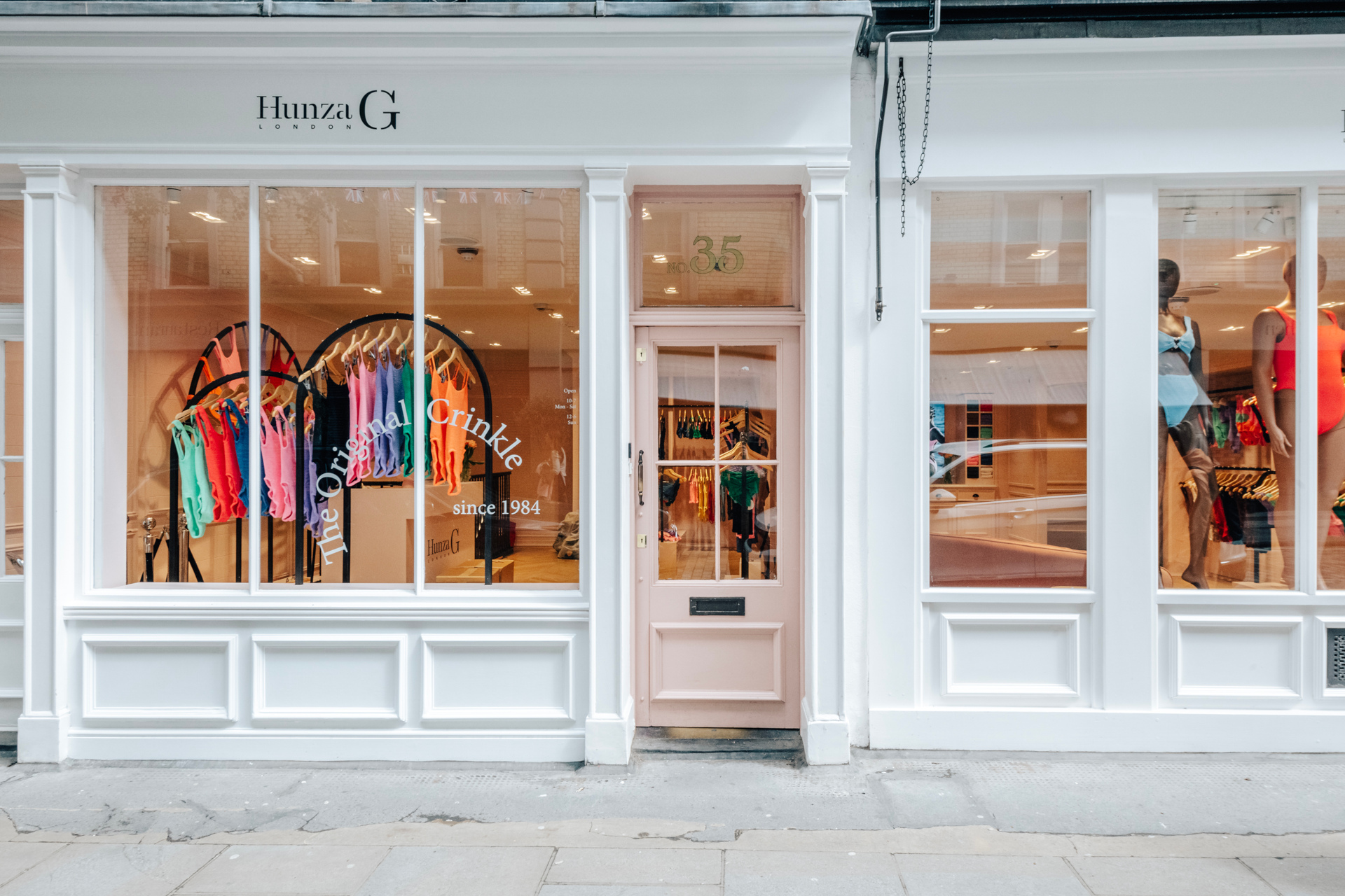 White store front with colourful swimming costumes in the window