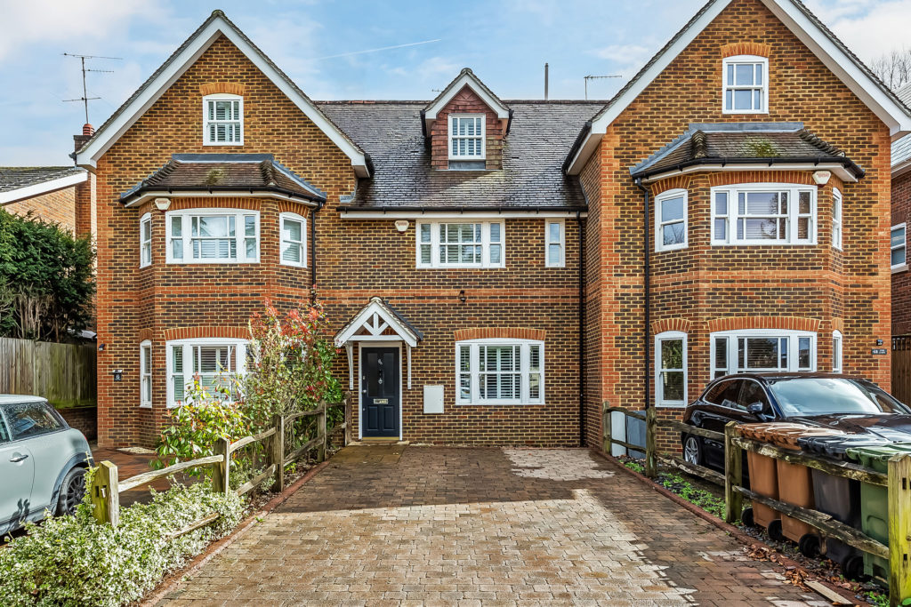 Red brick homes with large driveways and white fixtures.