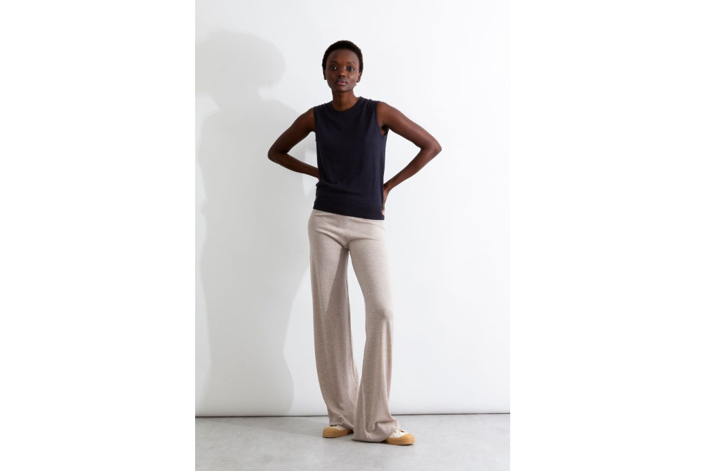 Woman in navy vest and cream trousers