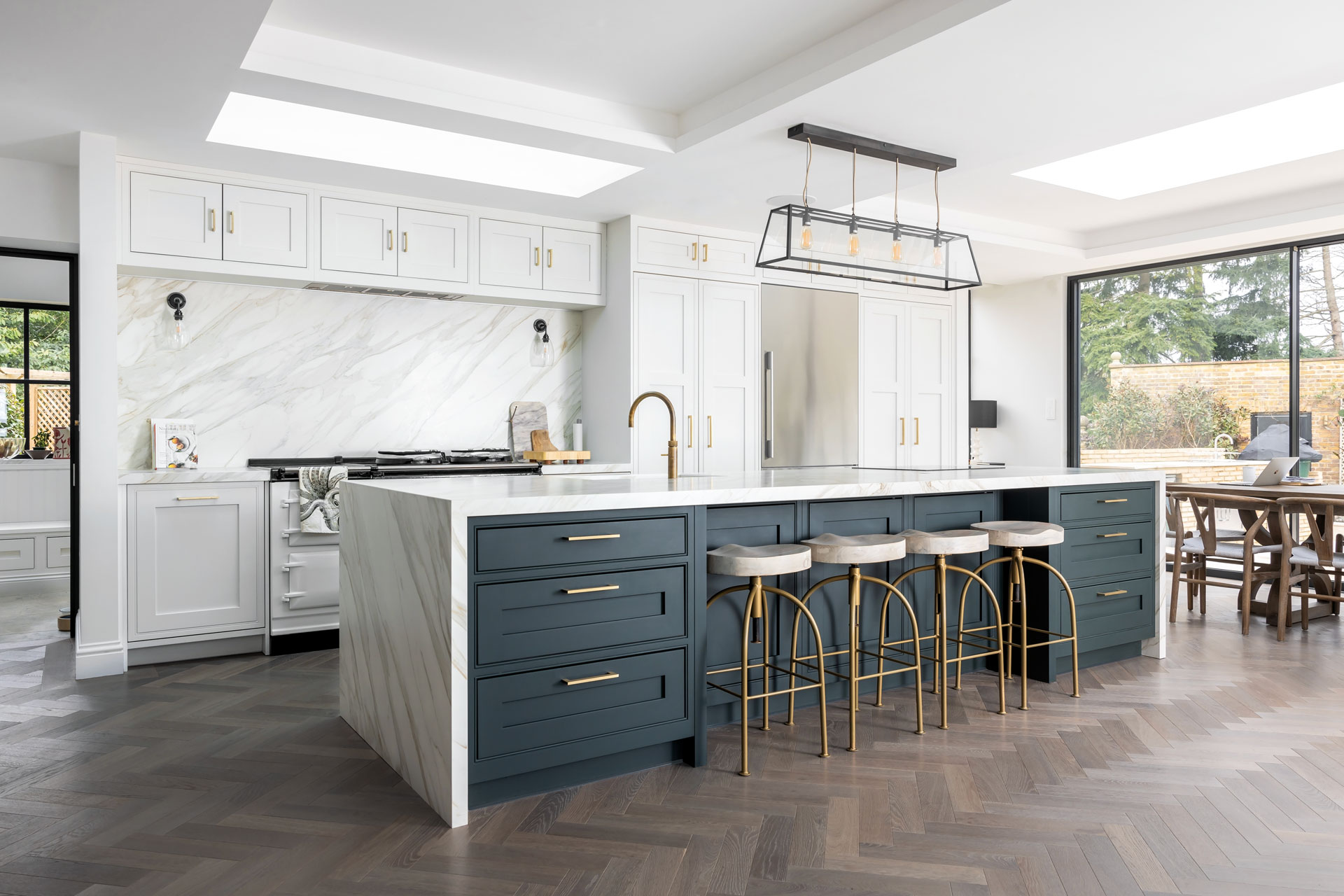 A kitchen island with stools by Life Kitchens