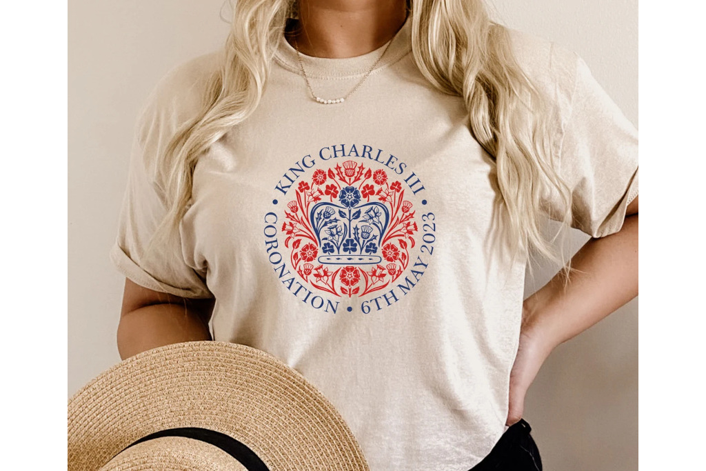 Woman wearing shirt with coronation emblem