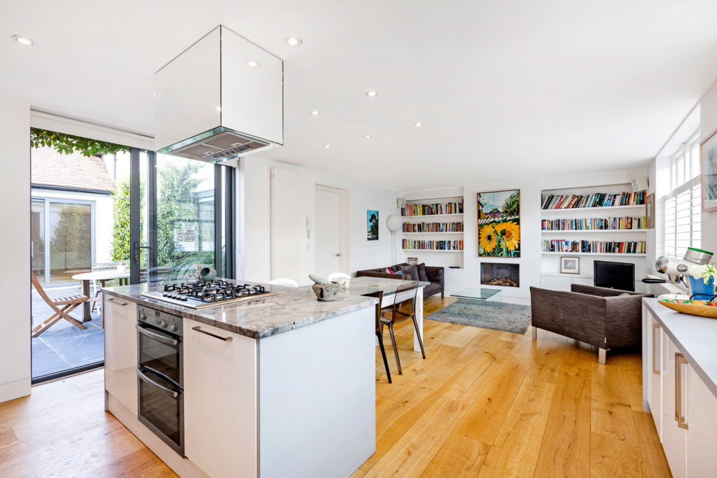 Modern kitchen with white units and grey marble worktops.