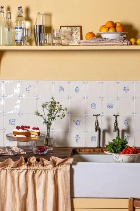 Yellow kitchen with white and blue Delft tiles from British brand Marlborough Tiles
