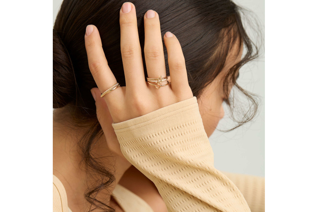 Close up of woman with arm up showing rings