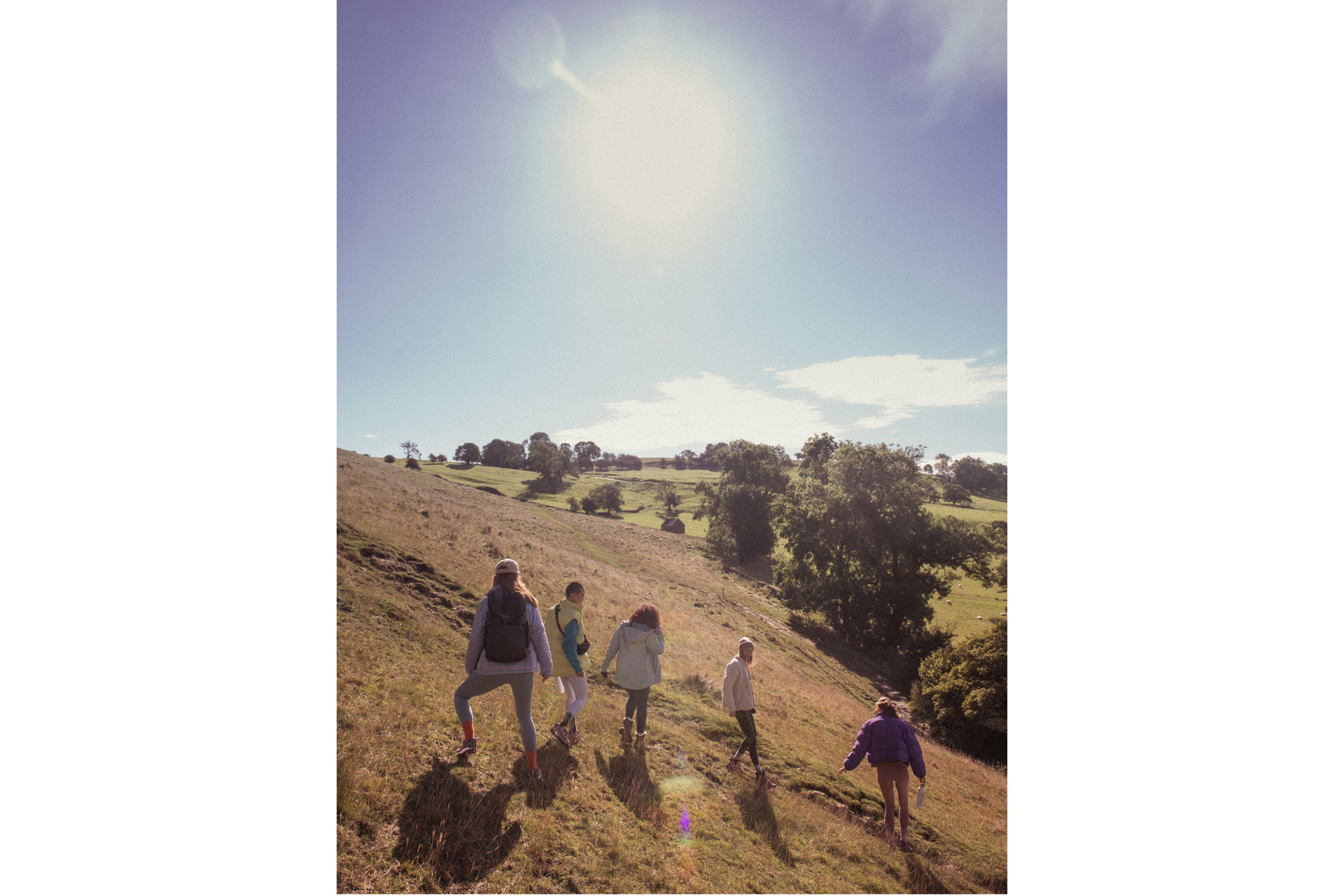 Women hiking through a field