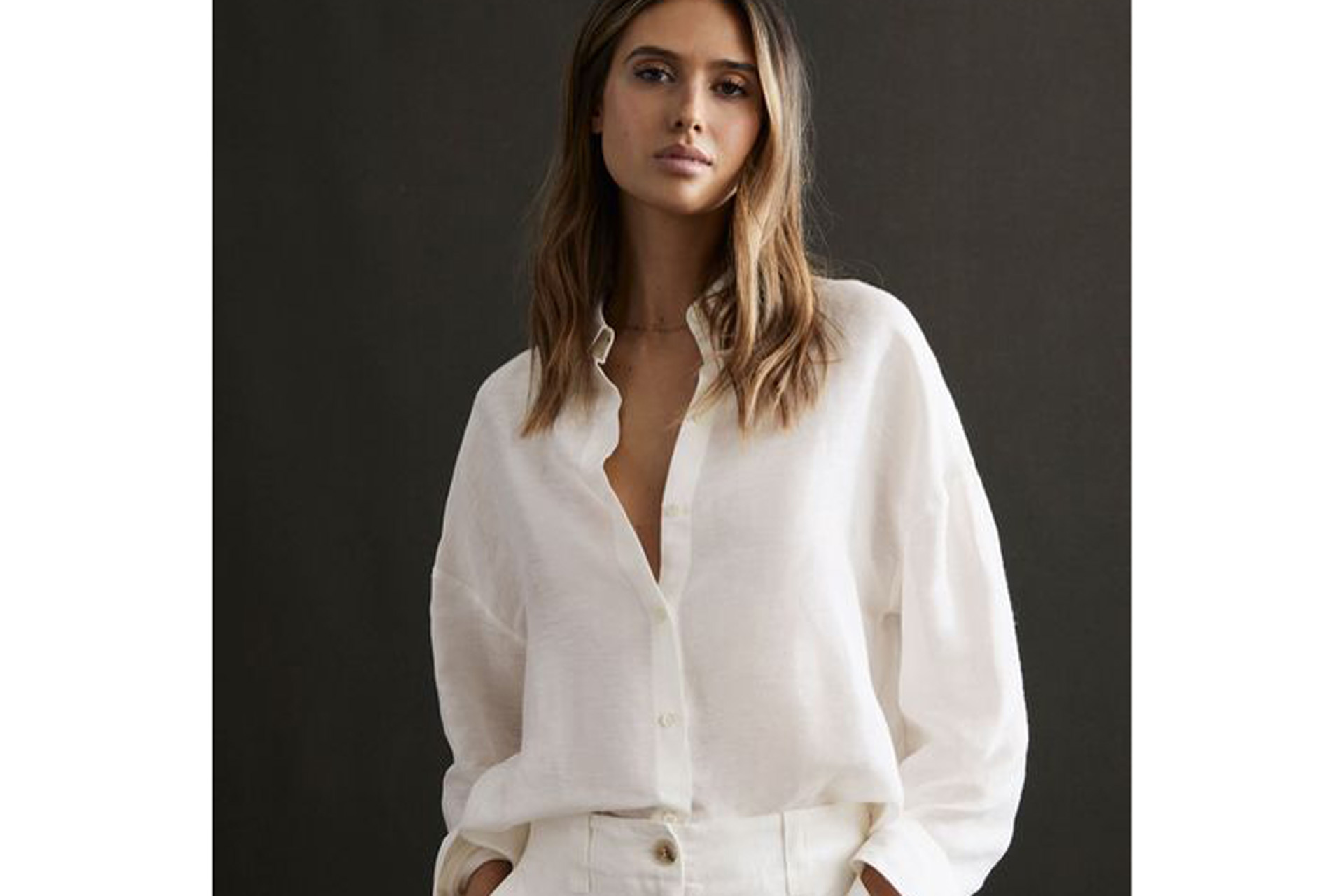 White linen shirt paired with matching trousers.