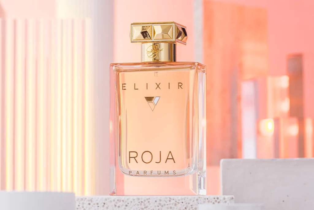 Pink perfume bottle on pink background