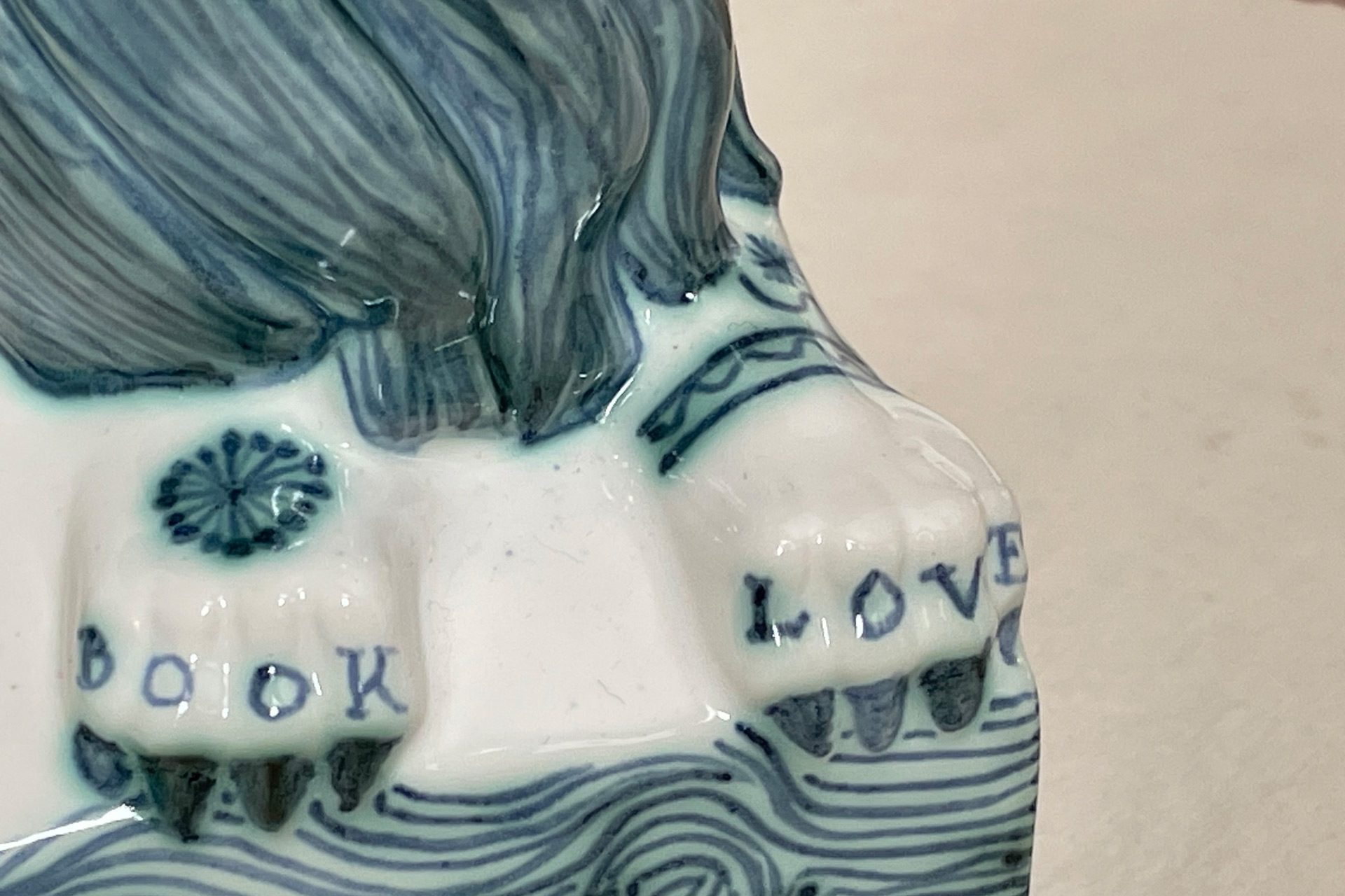 Details of Rye Potter's coronation bookends: unicorn hooves inscribed with the words 'book' and 'love'.