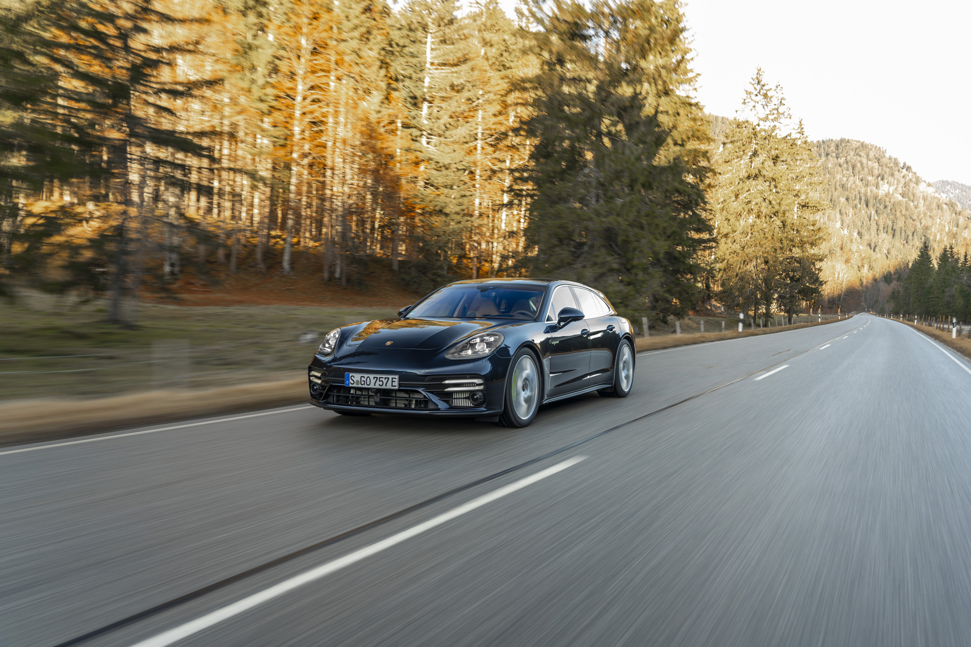 The Porsche Panamera Turbo S E-Hybrid Sport Turismo on a tree lined road