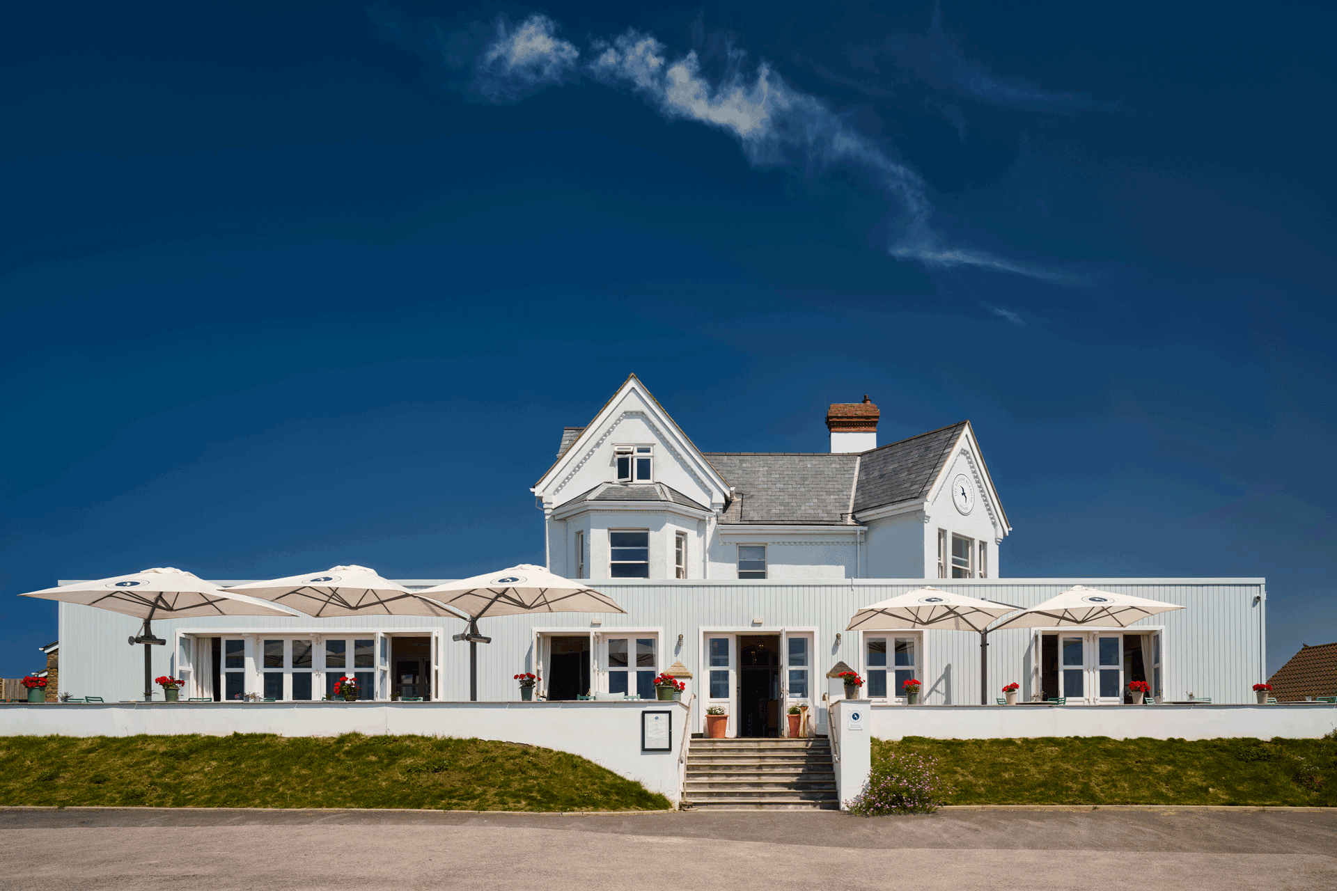 Exterior of The Seaside Boarding House, a white-panelled hotel on the Jurassic Coast.