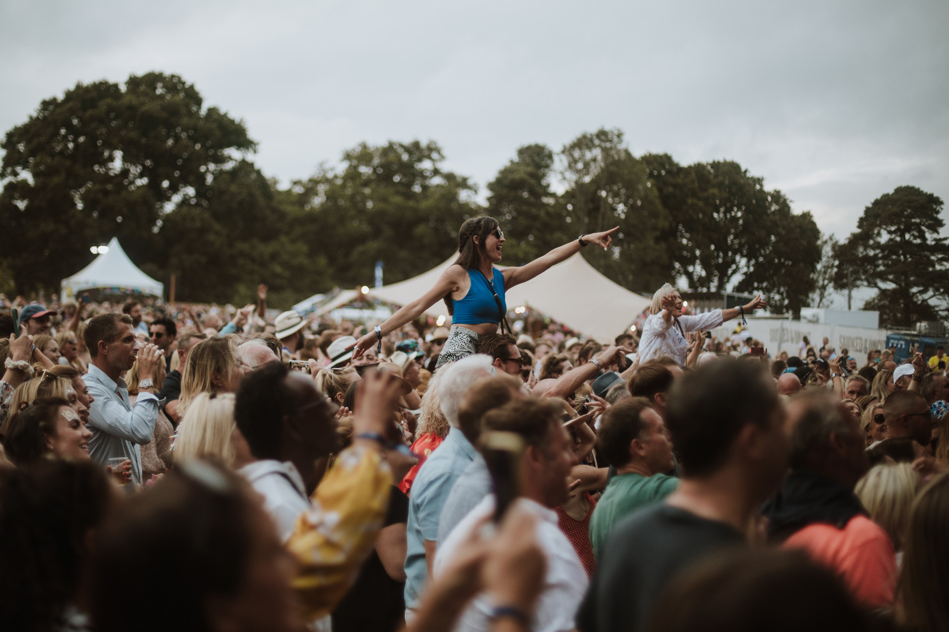 Woman on friend's shoulders in the crowd at Smoked and Uncut festival.