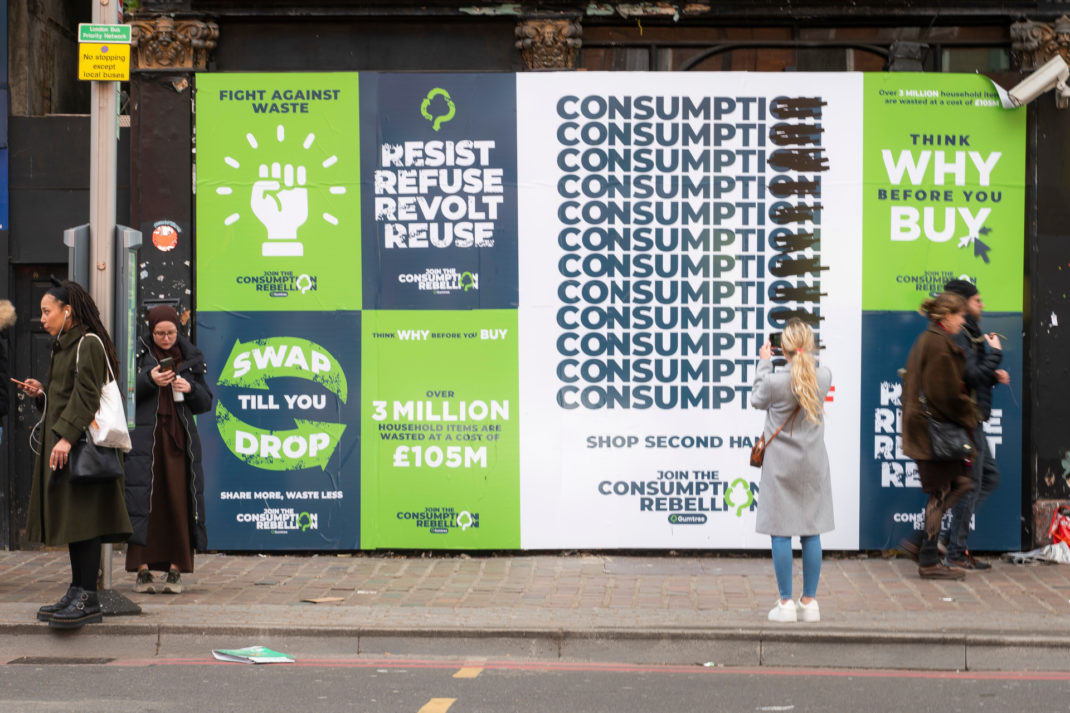 Posters on board on street in London