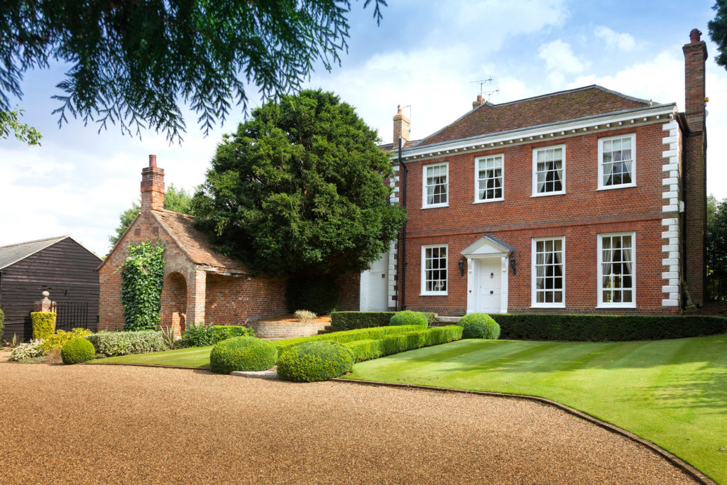 Georgian country house with red brick exterior and white trim.
