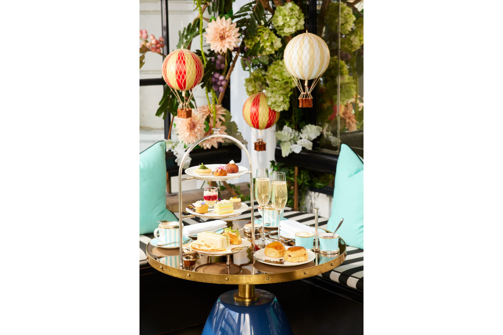Afternoon tea set up on table with mini hot air balloons