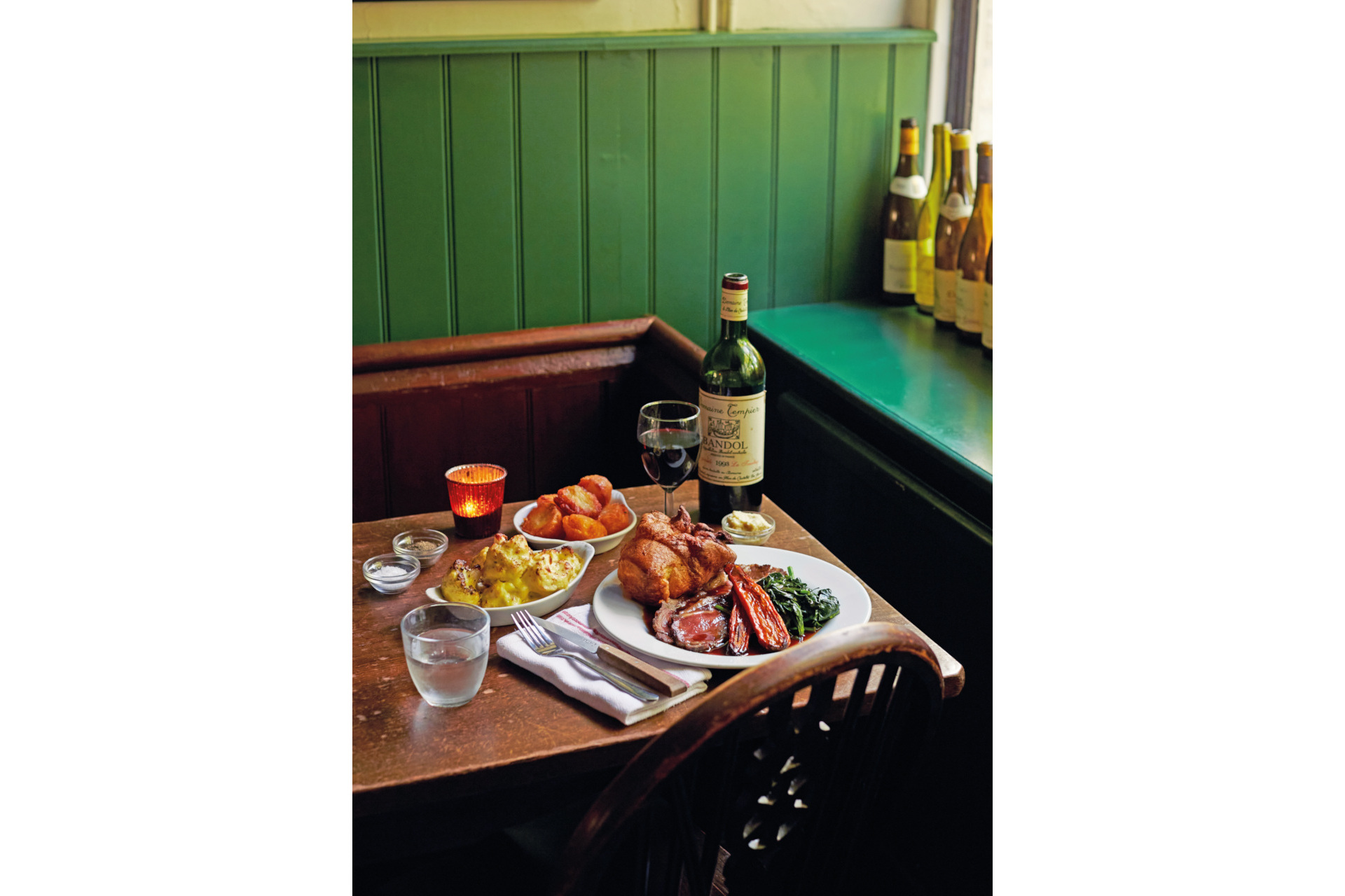 Close up of table set with food and drink, with green background
