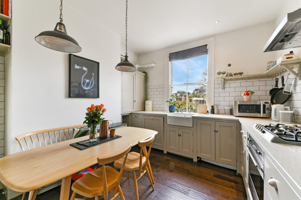 Contemporary kitchen with wooden dining room table and chairs.