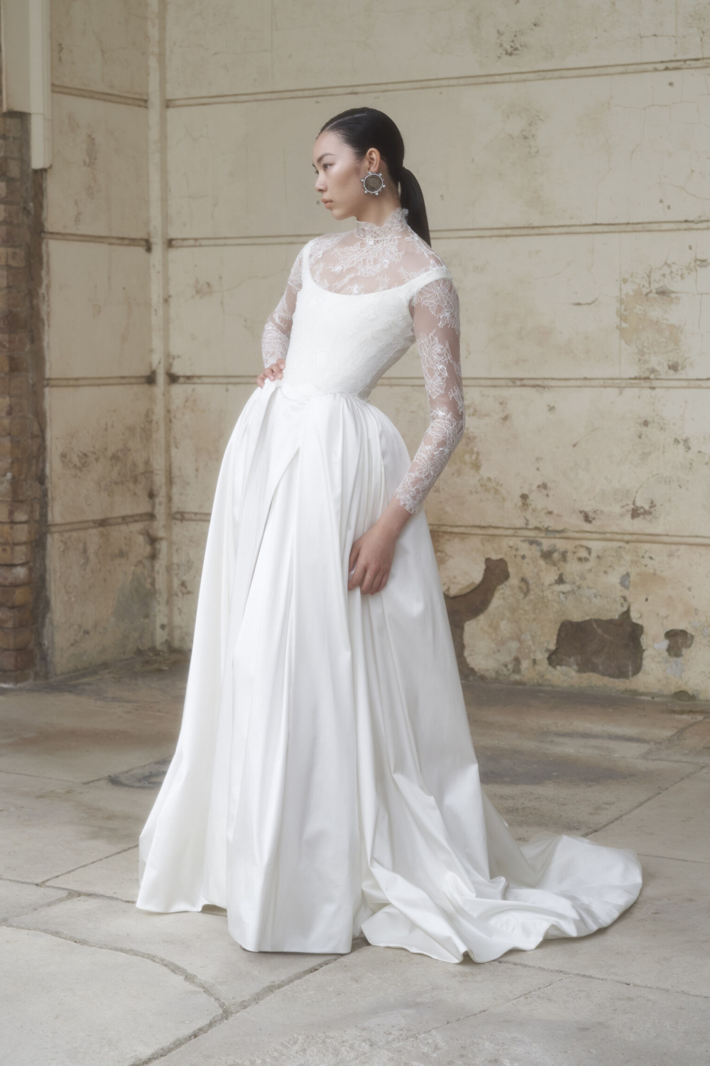 Woman in white gown with lace sleeves