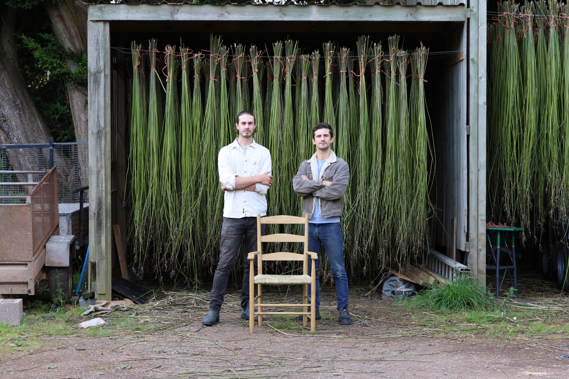 Two artisans standing behind a handmade