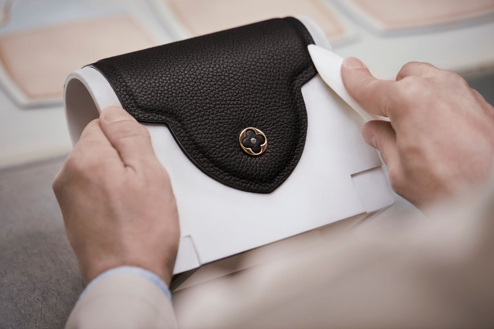 Artisan making a black and white Louis Vuitton Capucines bag