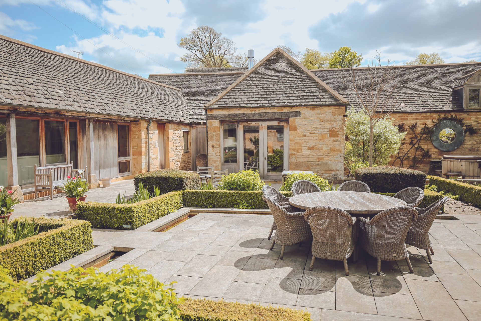 Large modern farmhouse with an internal courtyard