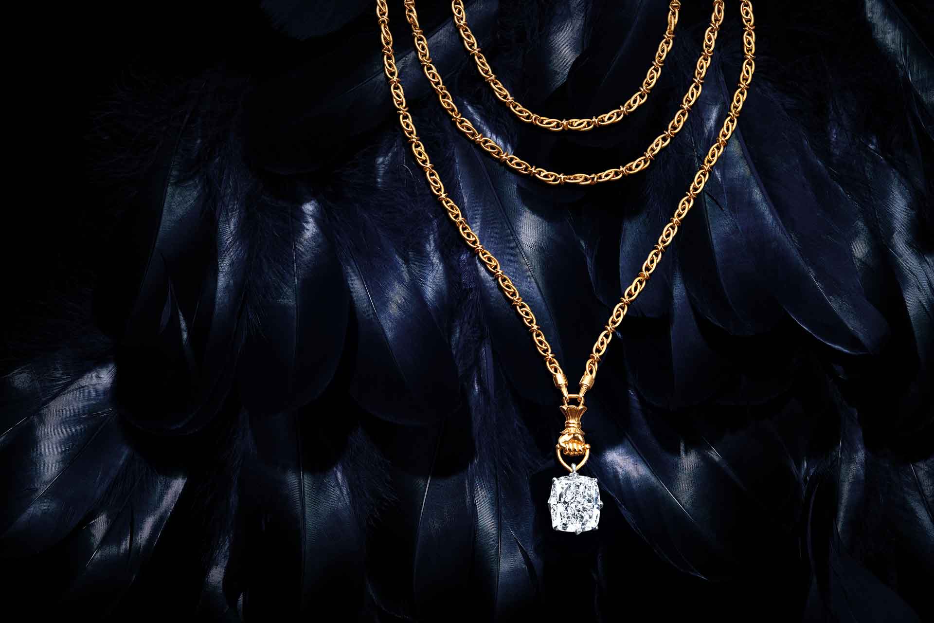 Square cut diamond necklace against a black background