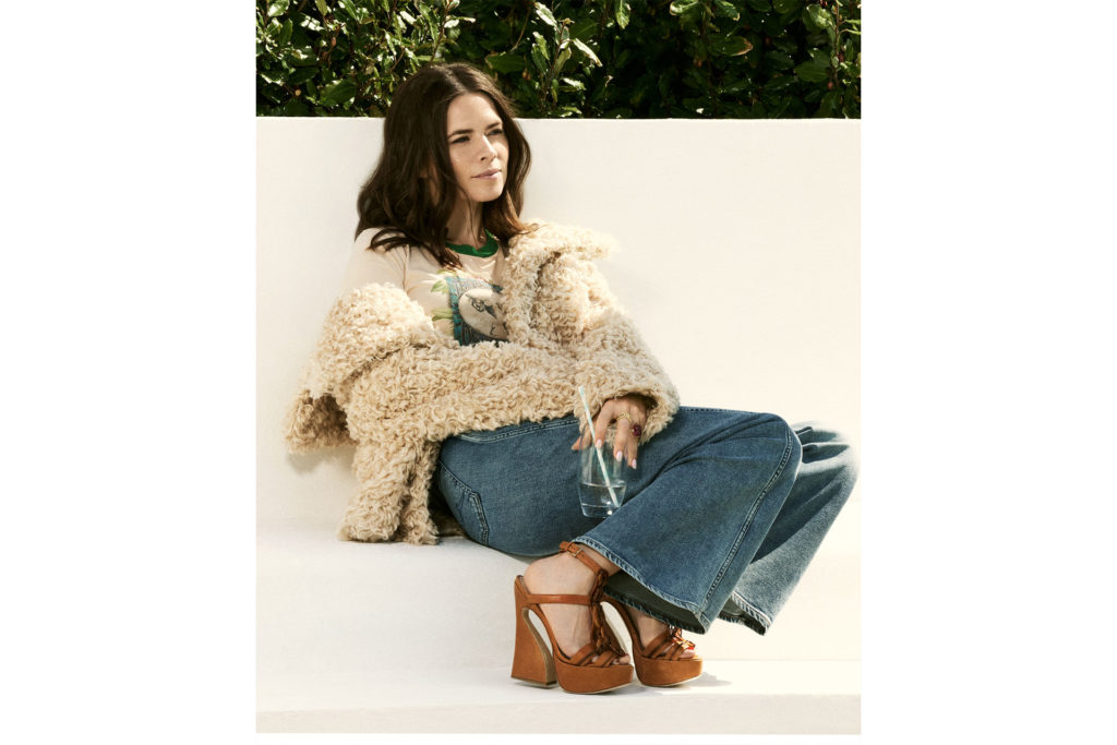 Hayley Atwell sits in fluffy coat