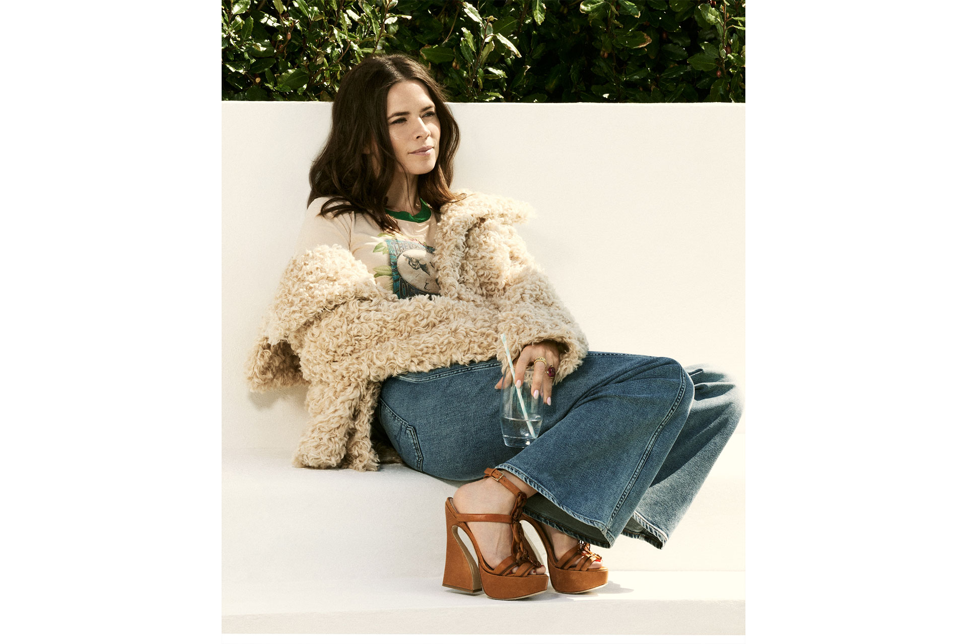 Hayley Atwell sits in fluffy coat